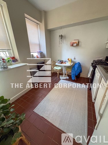 A kitchen area with a dining table and chairs.