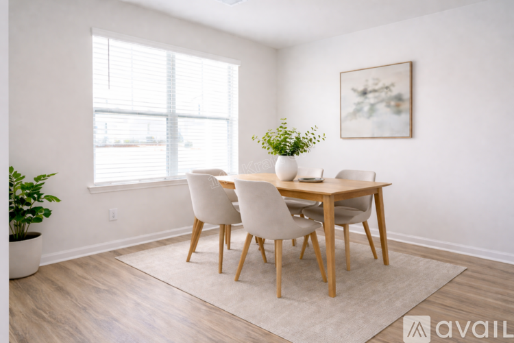 A dining room with a table and chairs.