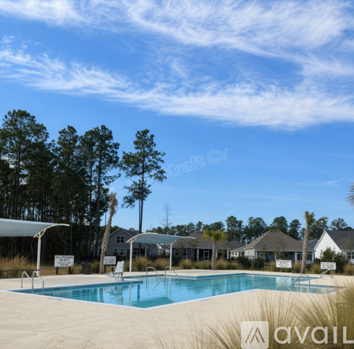 A swimming pool surrounded by trees and a clear blue sky.