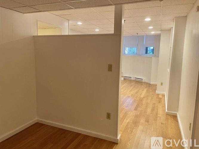 A room with wooden floors and white walls.