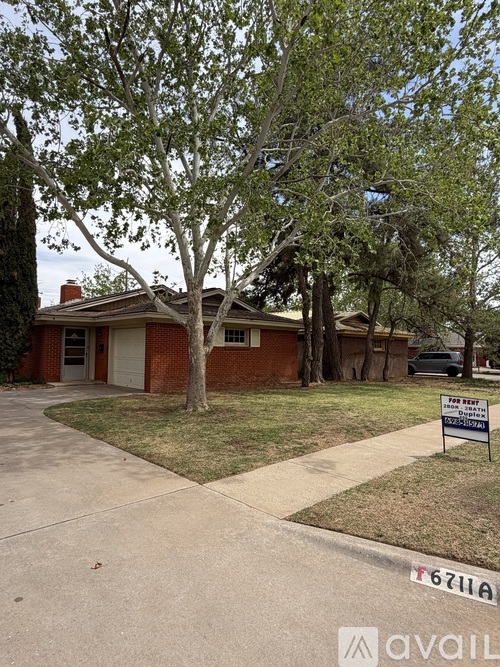 A house with a for sale sign in front of it.