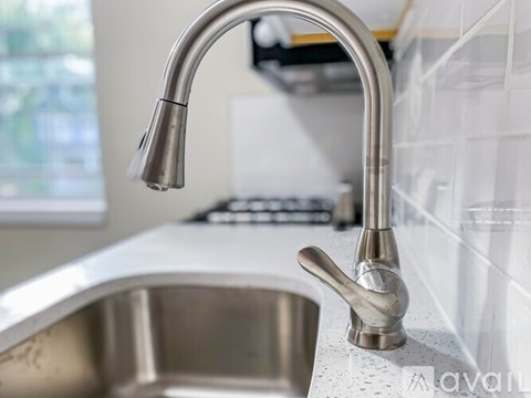 A modern kitchen sink with a chrome faucet.