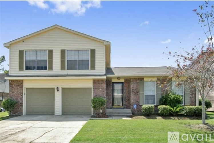 A house with a garage and a front yard.