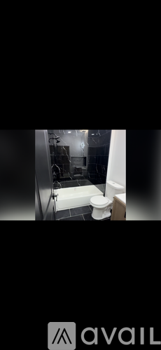 A bathroom with a toilet, sink, and bathtub.