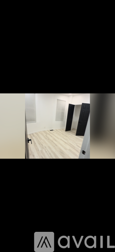 A room with a wooden floor and white walls.