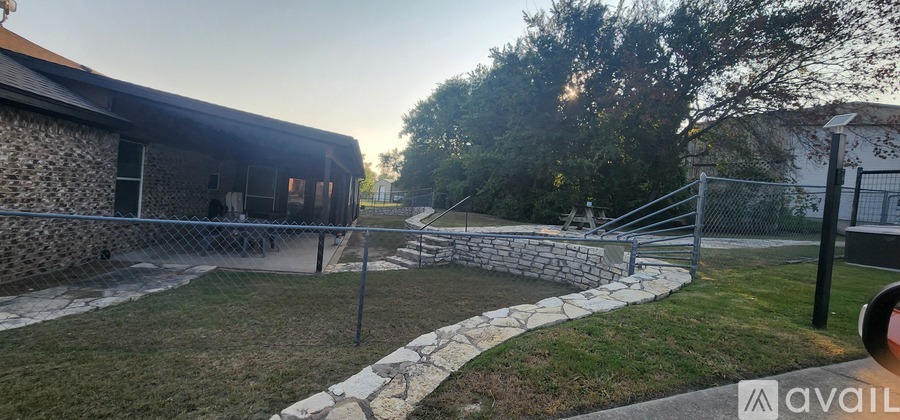 A stone building with a metal fence in front of it.