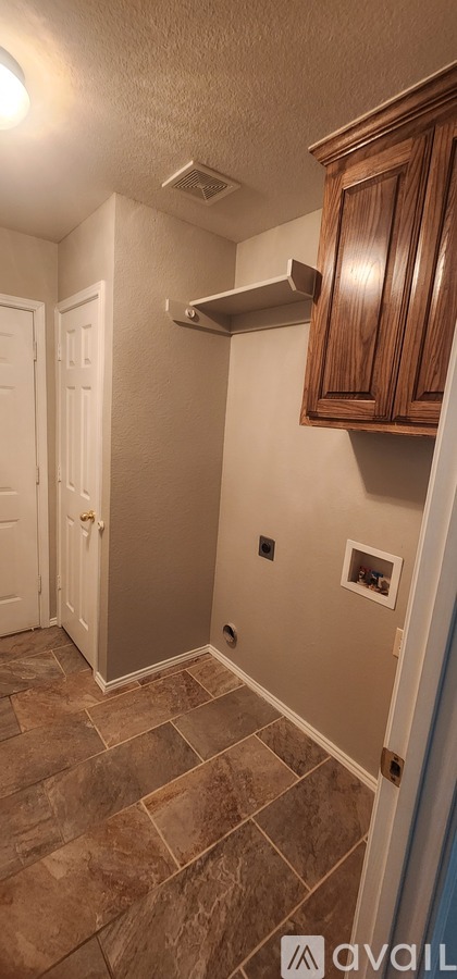 A kitchen with wooden cabinets and a tile floor.