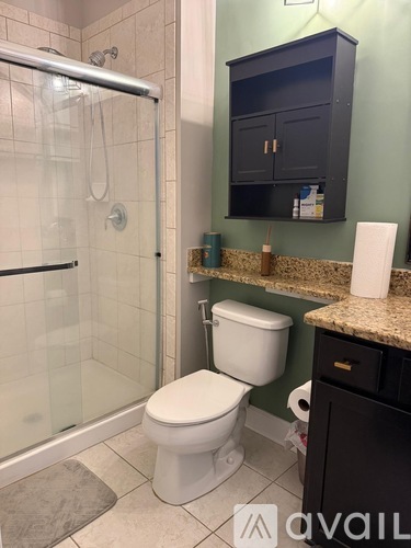 A white toilet in a bathroom with a glass shower door.