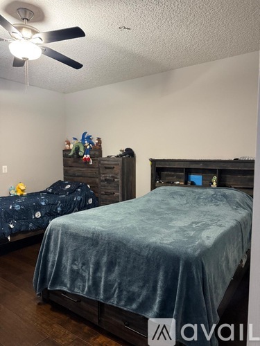 A bedroom with a bed and a dresser.