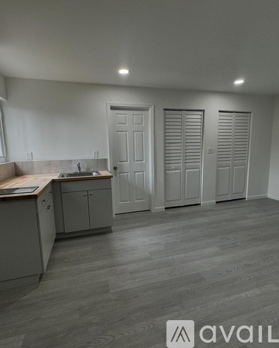 A kitchen with a countertop and cabinets is available for rent.
