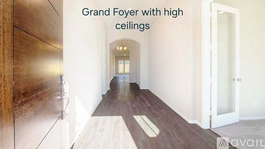 A long hallway with wood floors and high ceilings.