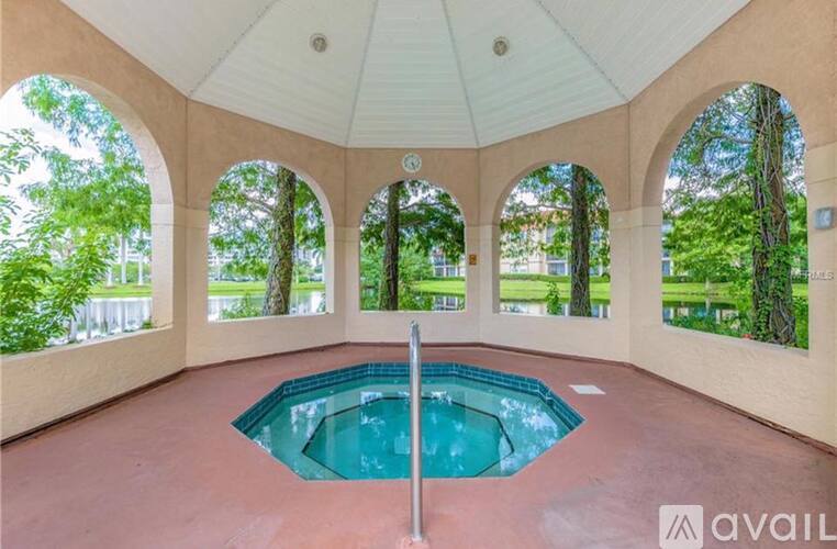 A round pool in a pavilion with arches.