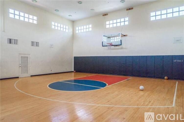 A basketball court with a ball on the floor.