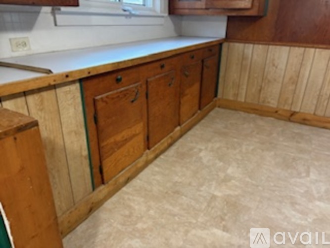 A kitchen with wooden cabinets and a counter top.