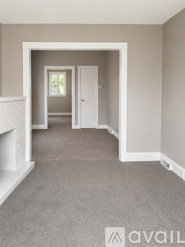 A room with a fireplace and a carpeted floor.