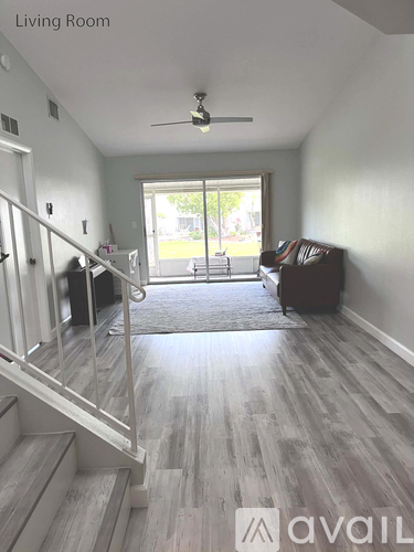 A living room with a staircase leading to the upper floor.