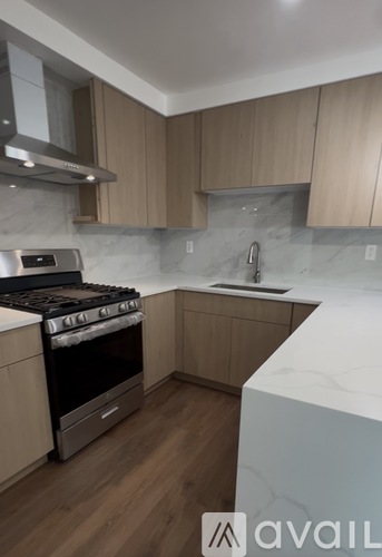 A kitchen with a stove top oven and a sink.