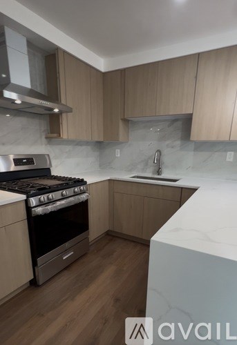 A kitchen with a stove top oven and a sink.