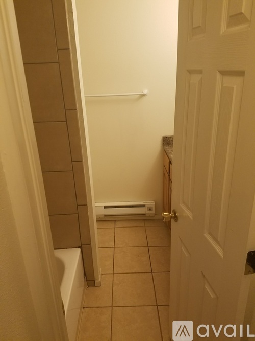 A white door is open to a bathroom.