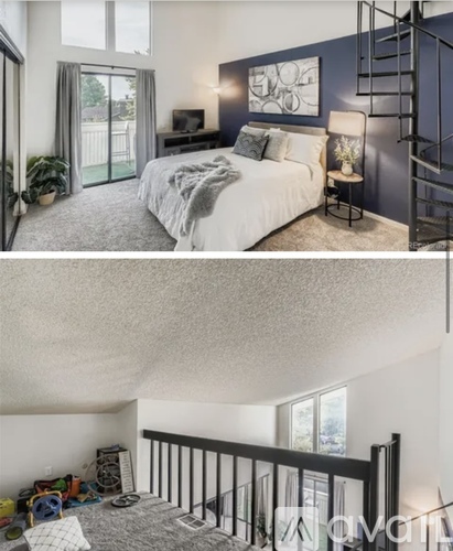 A bedroom with a bed, a chair, and a staircase.