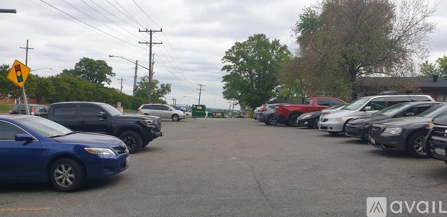 A parking lot with cars and a yellow warning sign.
