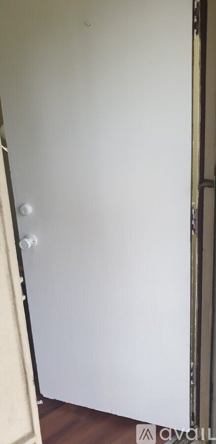 A white door with a silver handle is closed.