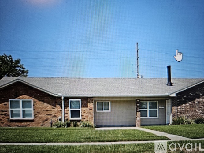 A house with a grey roof and a chimney.