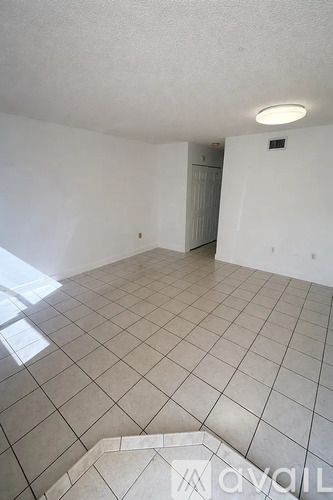 A room with white walls and a tiled floor.