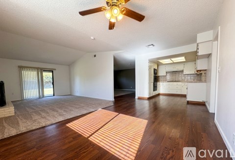 A living room with a ceiling fan and a television.