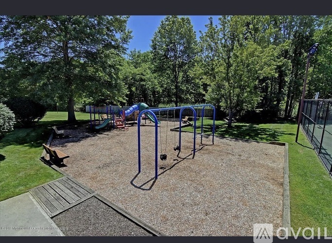 A playground with a swing set and a slide.