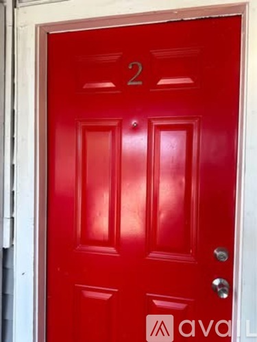 A red door with the number 2 on it.