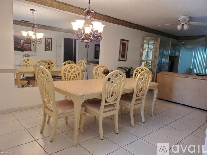 A dining room with a table and chairs.