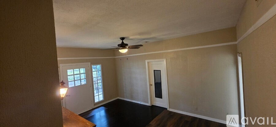 A room with a ceiling fan and a window.