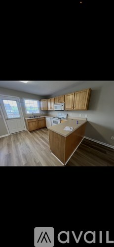 A kitchen with wooden cabinets and a white countertop.