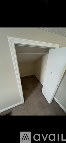 A white door is open in a room.