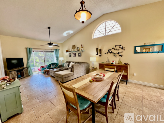 A dining room with a wooden table and chairs.