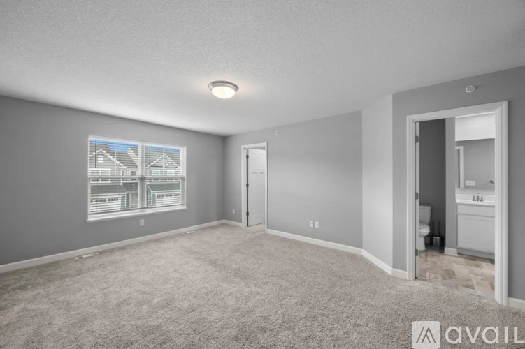 A spacious room with a carpeted floor and a picture on the wall.