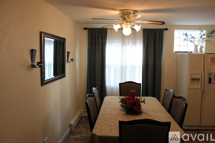 A dining room with a table set for six.