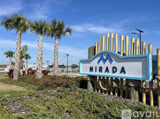 A sign that says "Mirada" in front of some palm trees.