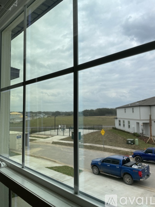 A blue pickup truck is parked in a lot.