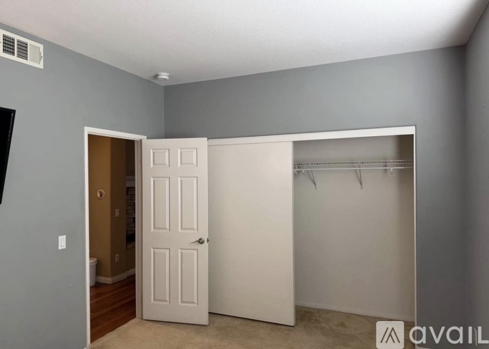 A room with a white door and a white closet.