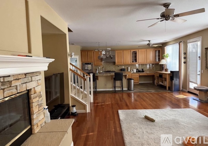 A living room with a fireplace and a rug on the floor.