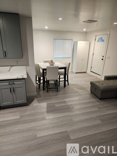A dining room with a table set for four.