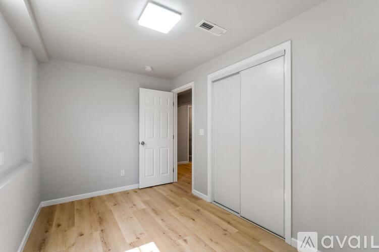 A room with a white door and a white cabinet.