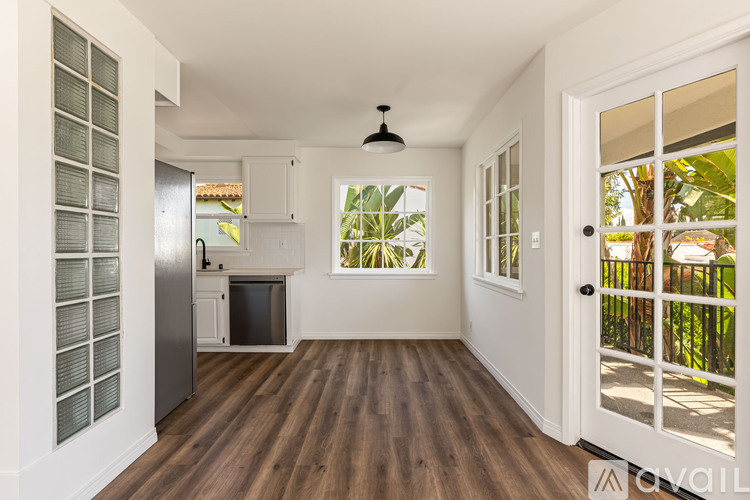 A kitchen with a refrigerator, microwave, and oven is shown.