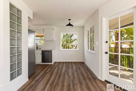 A kitchen with a refrigerator, microwave, and oven is shown.