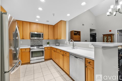 A kitchen with wooden cabinets and stainless steel appliances.