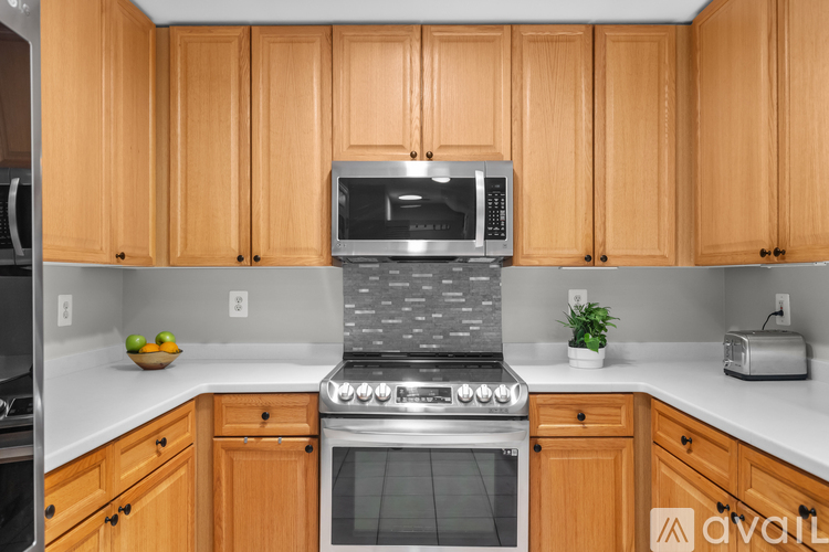 A kitchen with wooden cabinets and a stove top oven.