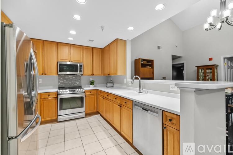 A kitchen with wooden cabinets and stainless steel appliances.