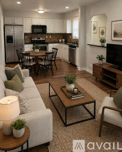A modern living room with a grey sofa, a coffee table, and a kitchen in the background.